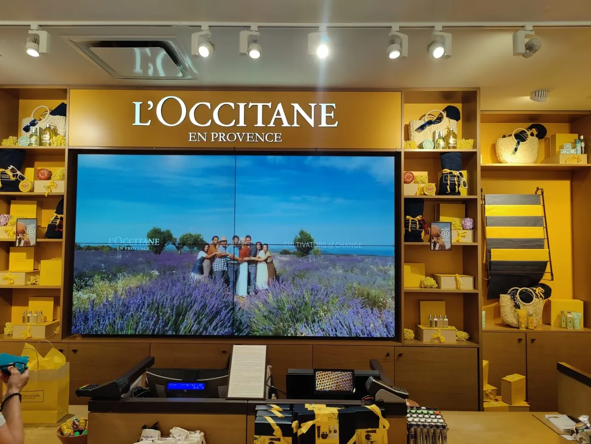 LCD 2x2 video wall above a counter in an L'Occitane boutique