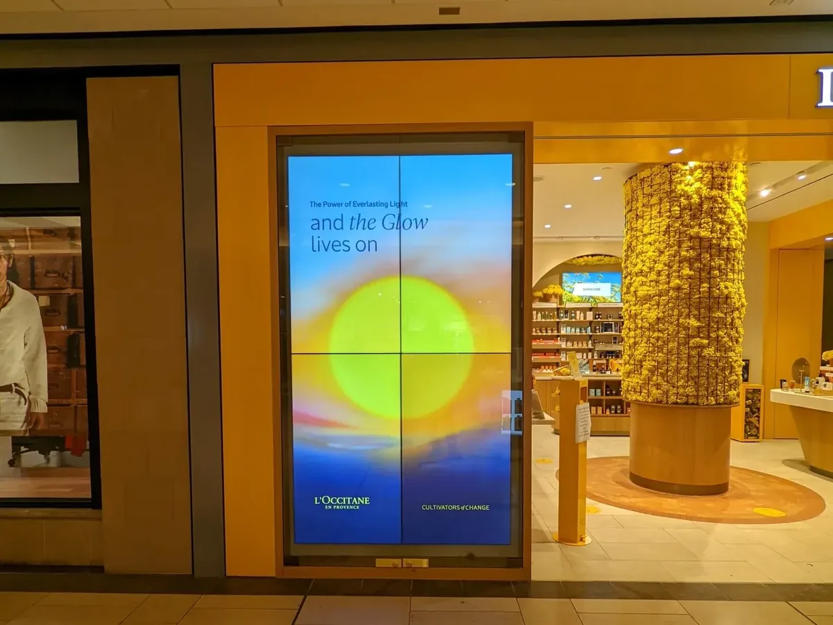 Portrait 2x2 LCD video wall at an L'Occitane storefront entrance